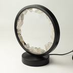 Angled view of the lamp's black frame and round base