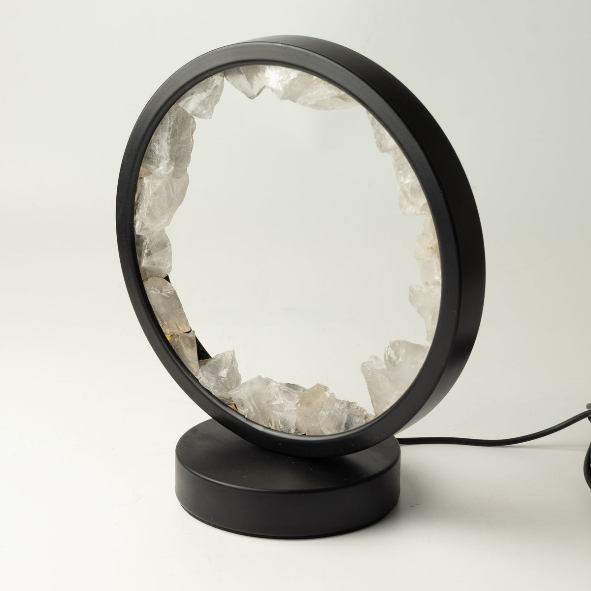 Angled view of the lamp's black frame and round base