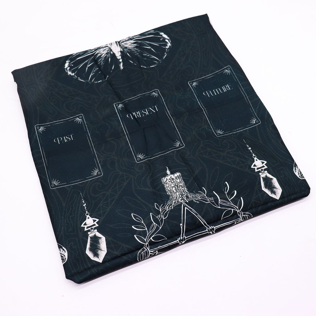Folded cloth showing the butterfly and card positions