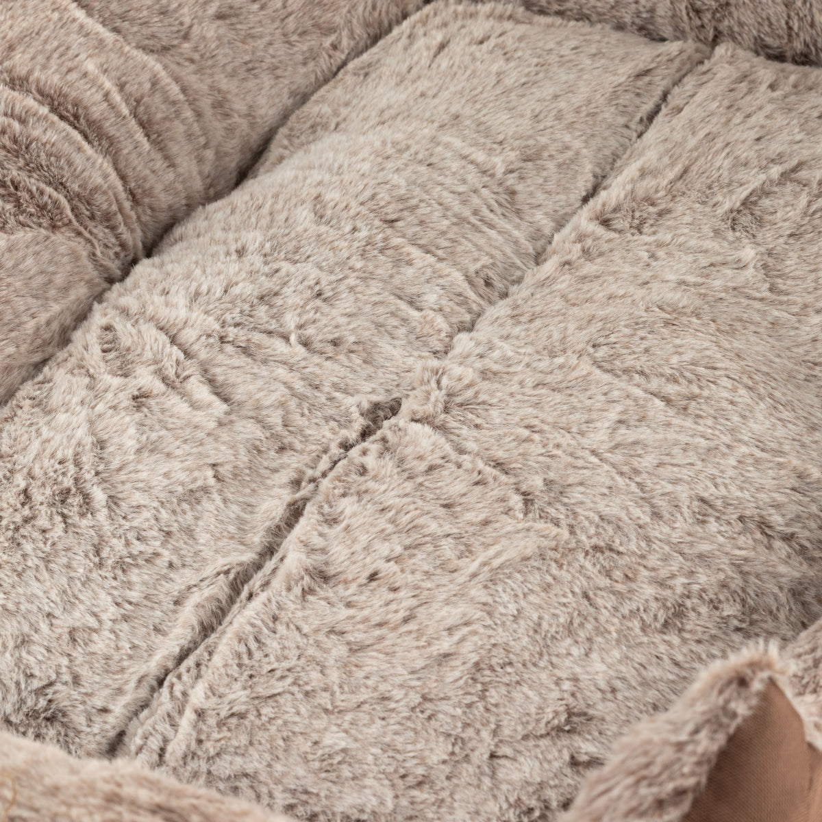 Close-up of the bed's textured plush sleeping surface