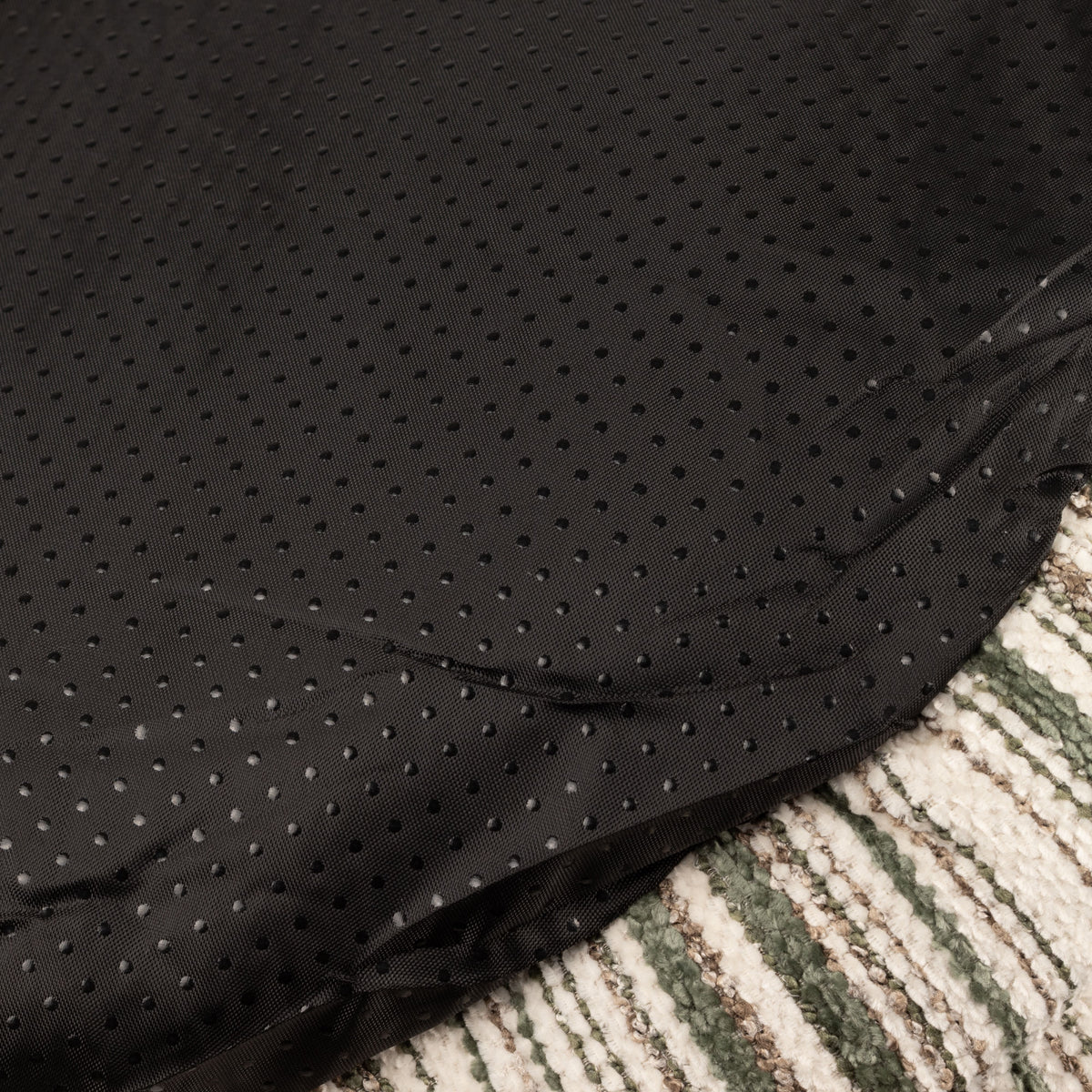 Close-up of the bed's dark textured base