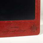 Close-up of the red notebook’s stitched screen border
