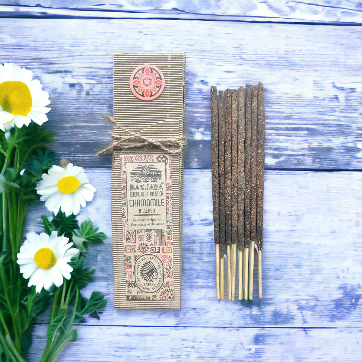Ritual Resin on Stick, Chamomile, brown sticks beside a labelled cardboard box with daisies