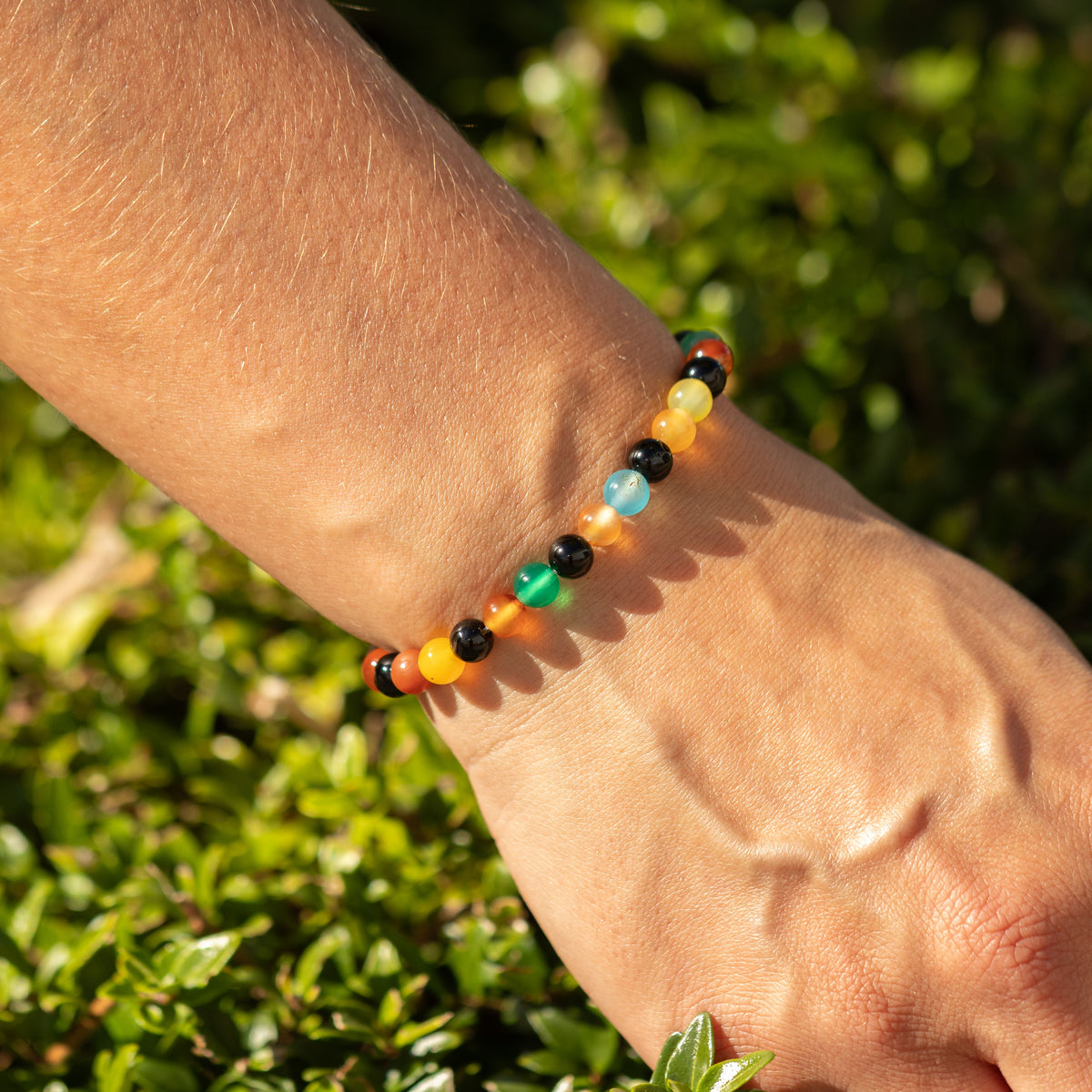 Rainbow Jade bracelet worn on a wrist outdoors