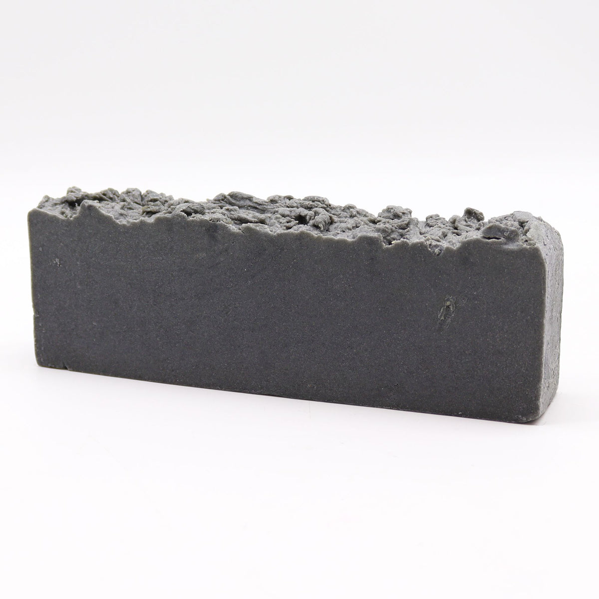 Olive oil soap loaf shown whole from the front, with a rough, uneven top on white