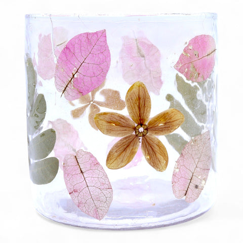 Front close-up of the Primavera holder showing pink leaves and a brown flower against clear glass