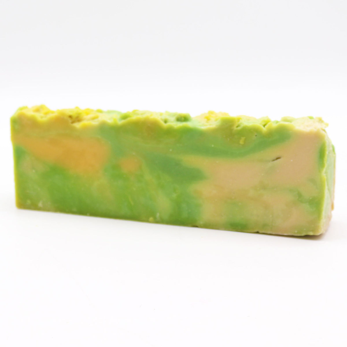 Noni soap loaf shown from the side, green and pale yellow swirls against a white background
