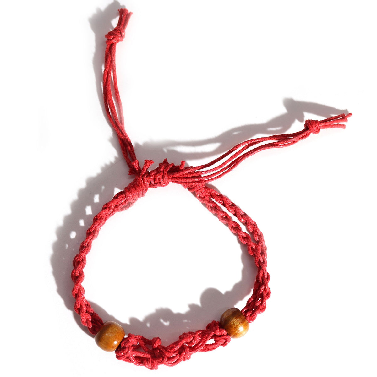 Red gemstone bracelet cord laid flat with two brown beads and adjustable loose ends, viewed from above