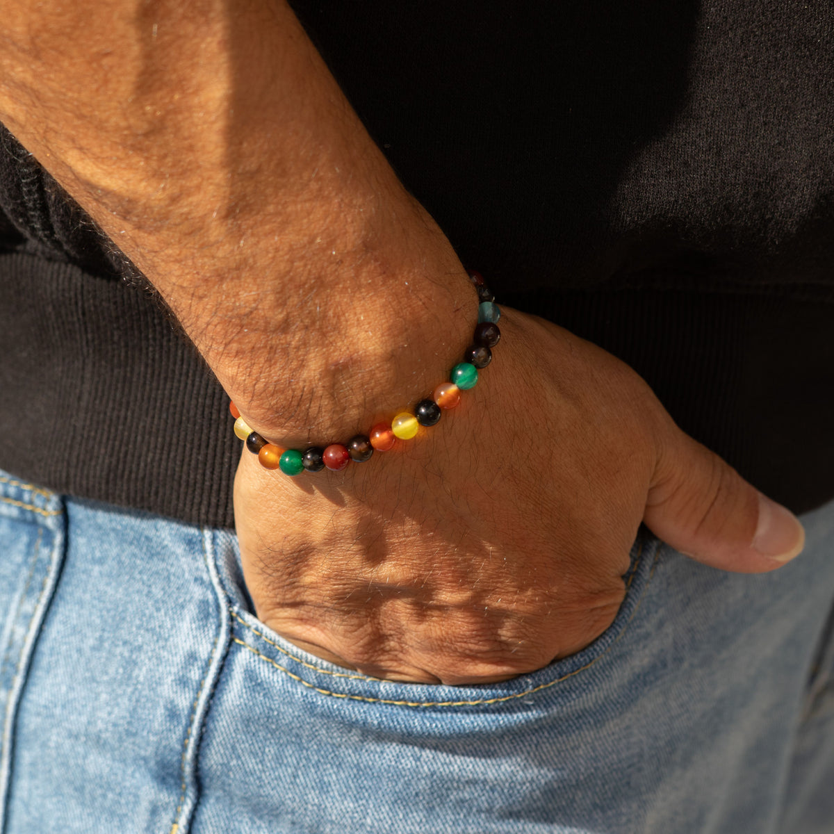 Bracelet worn at the wrist with a hand in a pocket