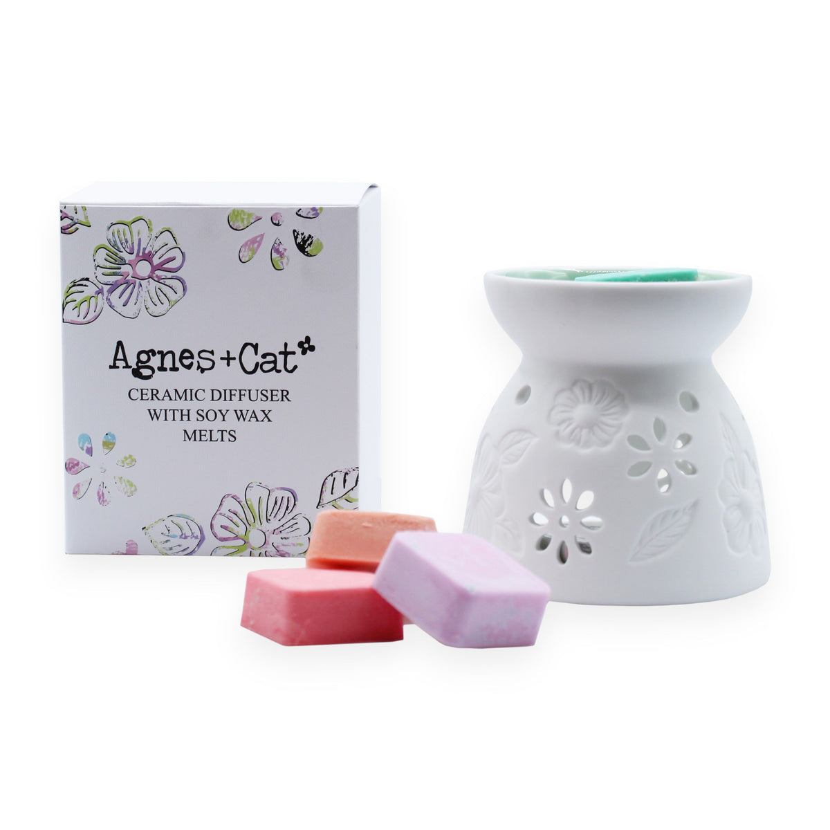 Wax Melter with Four Soy Wax Melts, white floral burner beside its box and coloured wax melts