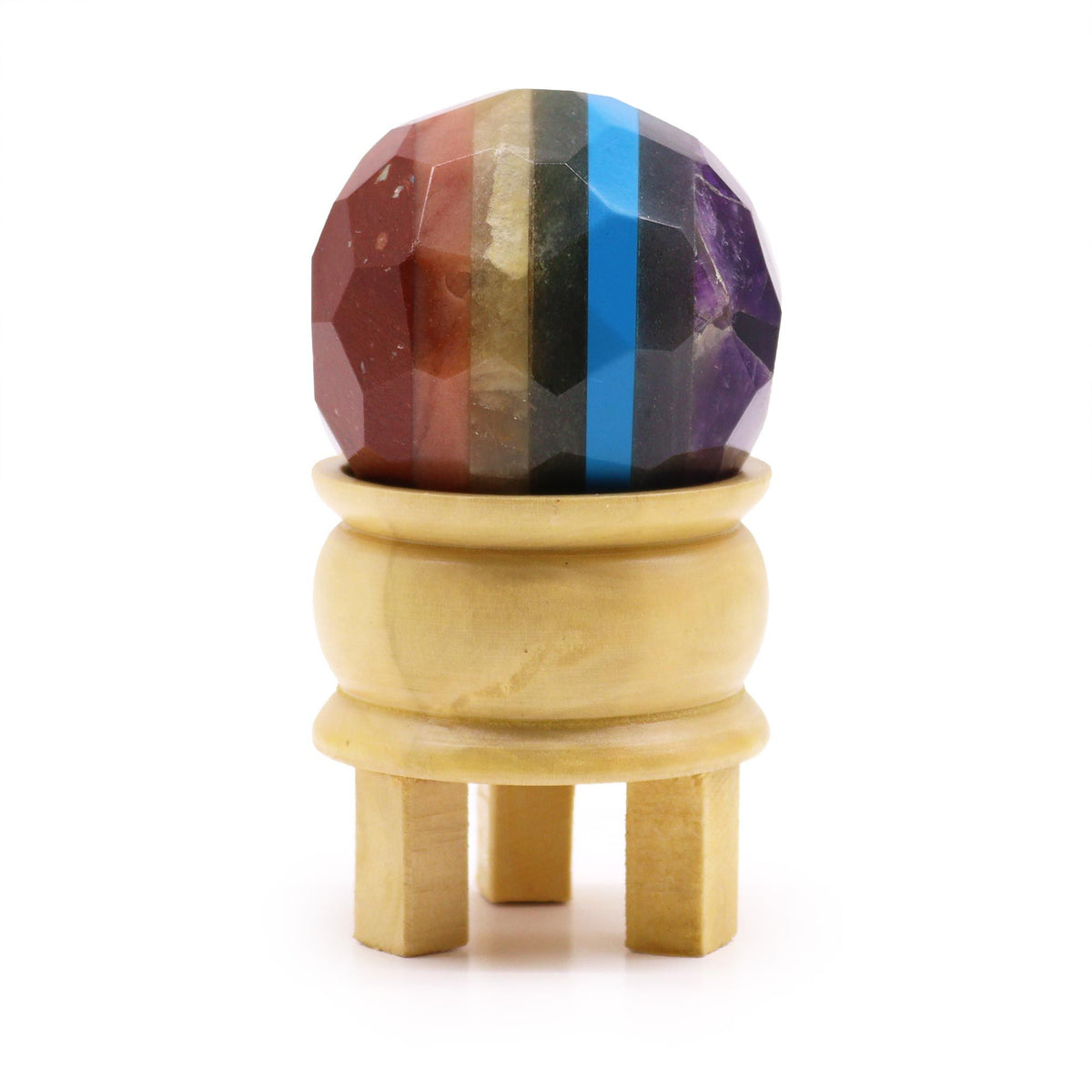 Faceted gemstone ball with coloured bands on a wooden stand