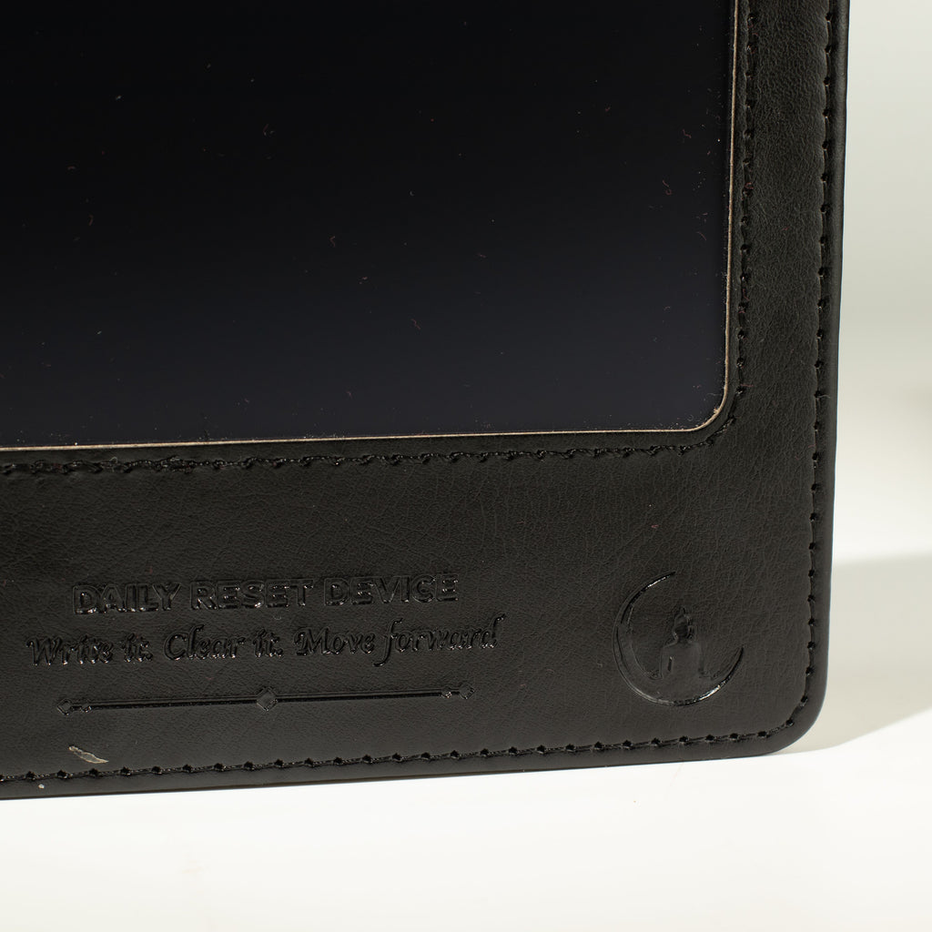 Close-up of black notebook screen and embossed cover wording