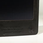 Close-up of black notebook screen and embossed cover wording