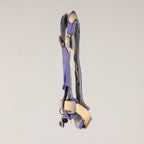 Side profile of the harness with its charm and adjustable straps