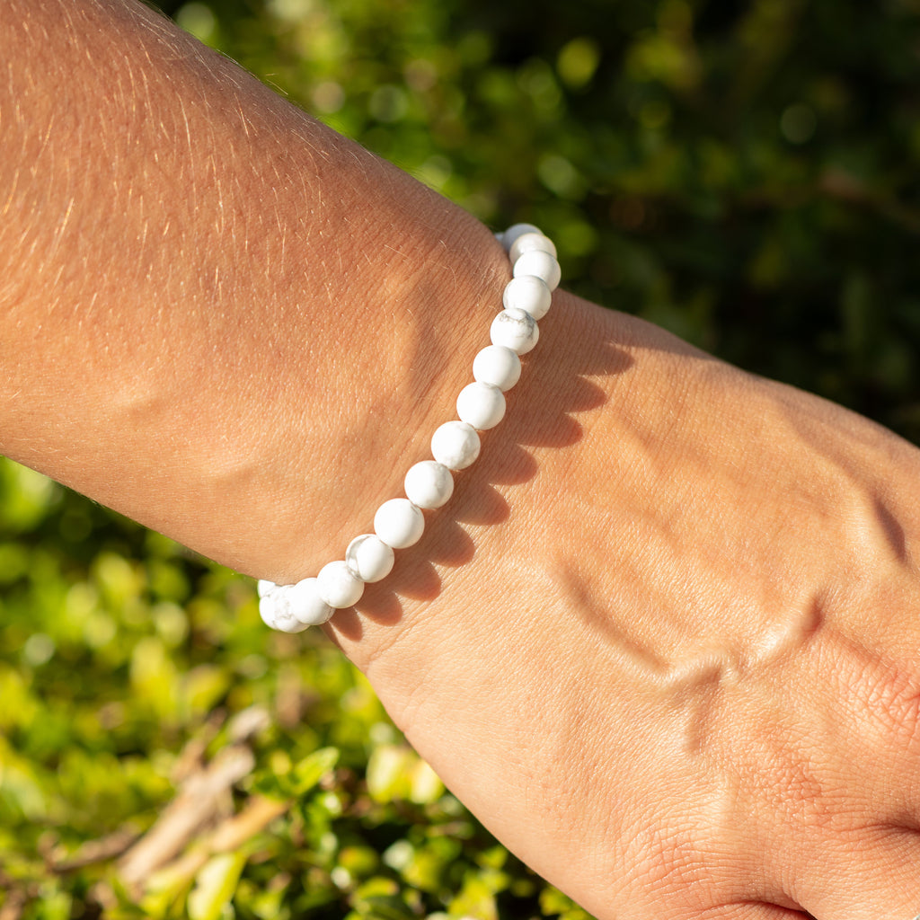 Howlite bracelet shown on a wrist in bright sunlight