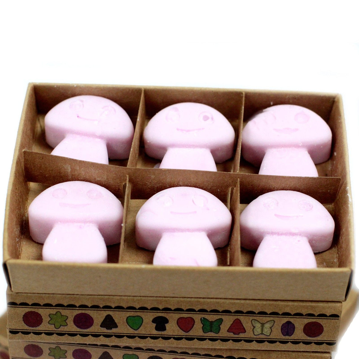 Six pink mushroom-shaped wax melts arranged in two rows inside an open divided kraft box