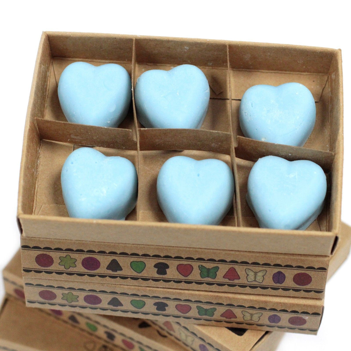 Dewberry wax melts, six pale blue heart shapes arranged in the open compartments of a kraft box