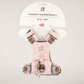 PAW soft pink dog harness with reflective details and paw charm, shown on packaging
