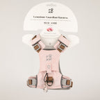 PAW soft pink dog harness with reflective details and paw charm, shown on packaging