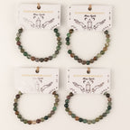 Several Moss Agate bracelets displayed on illustrated cards