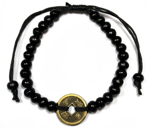 Black bracelet with round beads and a central coin