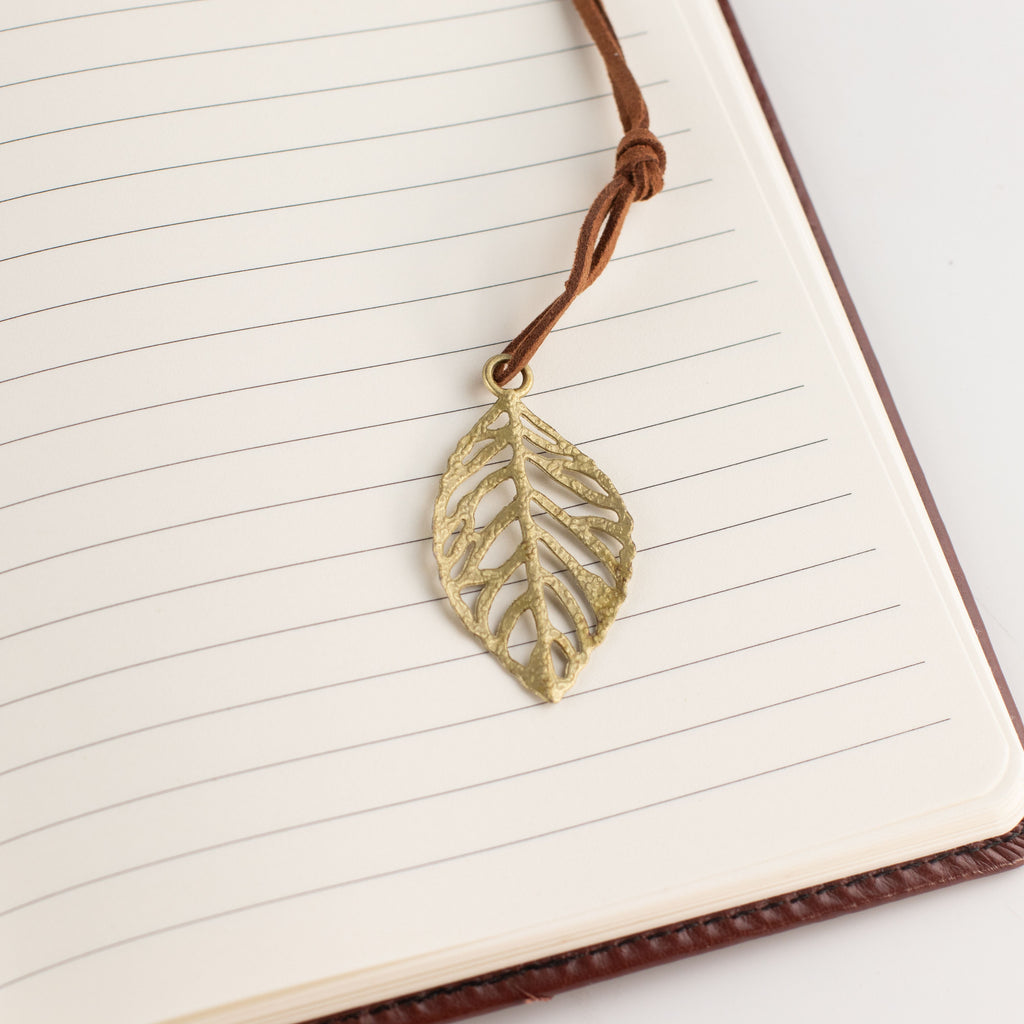 Close-up of the leaf-shaped bookmark on a lined page