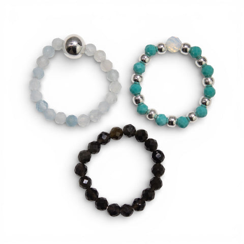 Three Endless Ocean gemstone rings, pale blue, black and turquoise, side by side