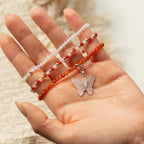 Three beaded bracelets laid across an open hand