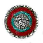 Round mosaic incense plate with a silver Om symbol on red and turquoise ceramic.