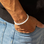 Howlite bracelet worn beside a jeans pocket