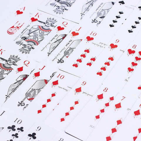 Memento Mori Gothic Playing & Oracle Cards spread across a white surface, with red and black suits
