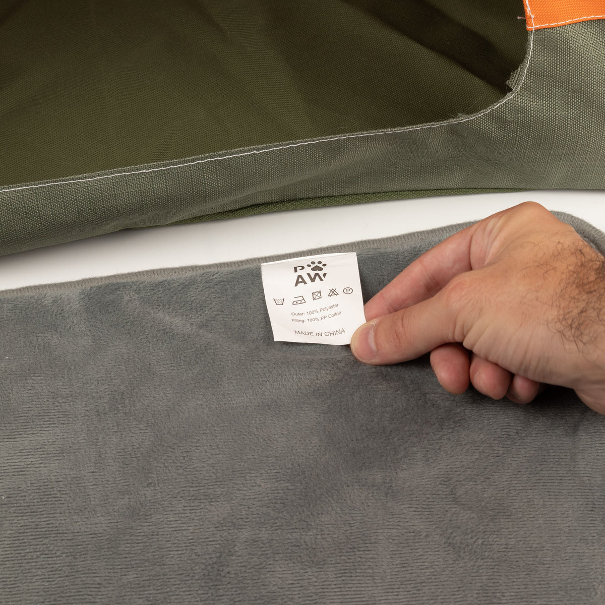 Close-up of the bed’s cushion and care label