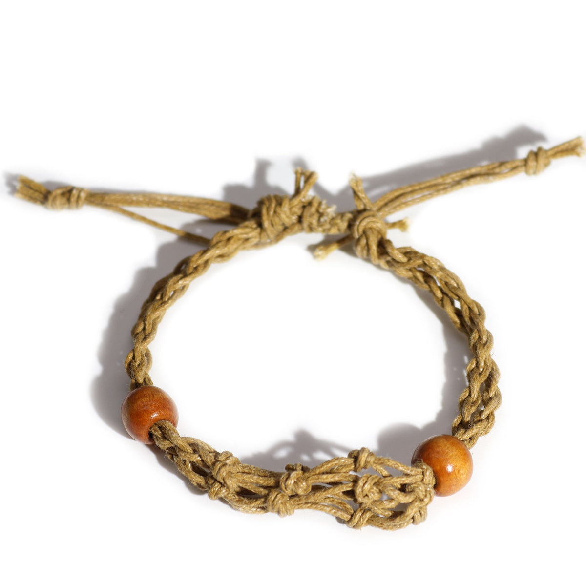 Sand bracelet cord viewed from above, showing braided strands, brown beads and knotted ends on white