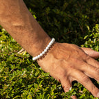 Howlite bracelet worn on a hand outdoors
