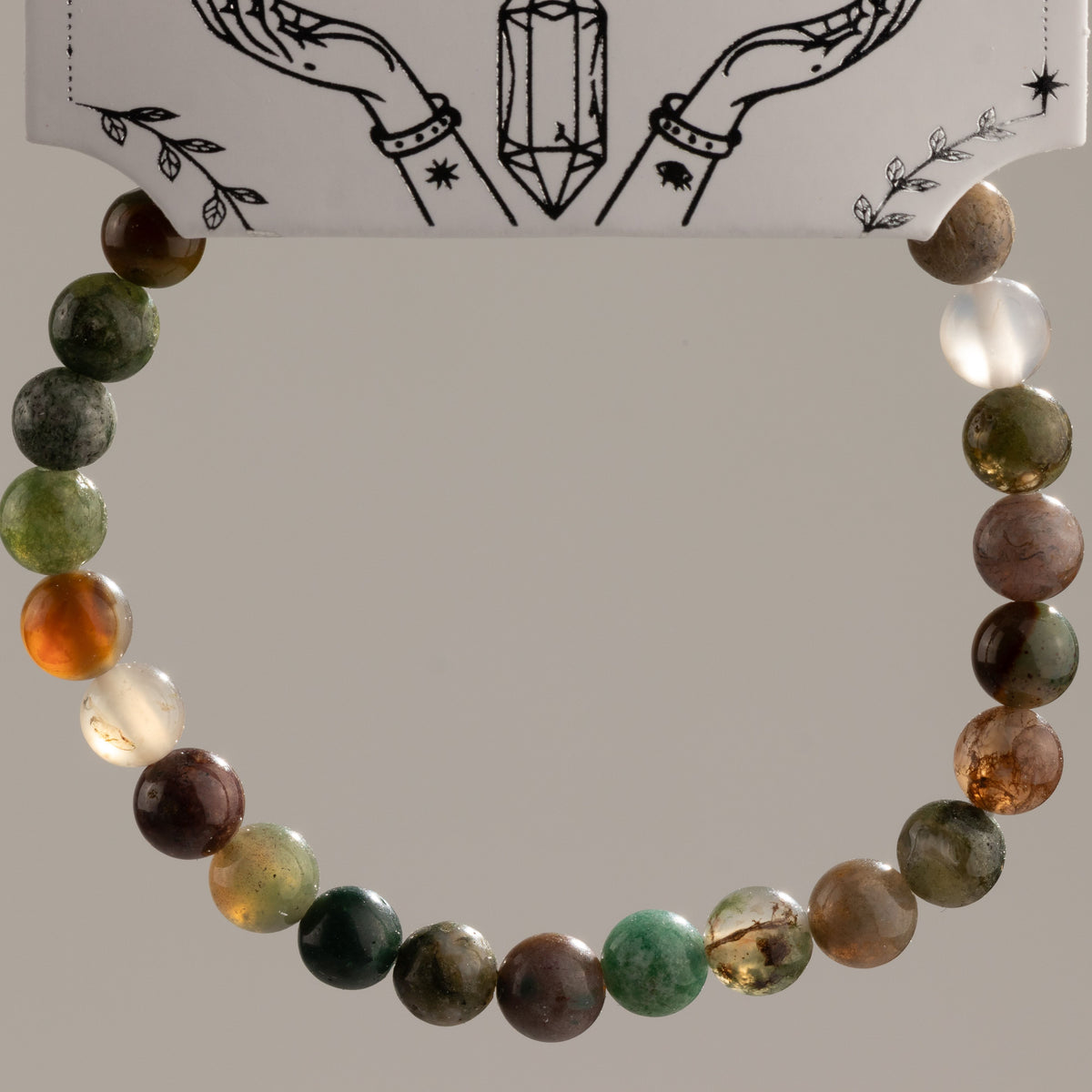 Moss Agate bracelet arranged in a circle to show the varied bead patterns