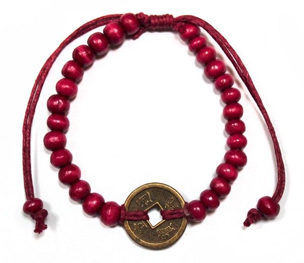 Red beaded bracelet with a coin charm in the centre