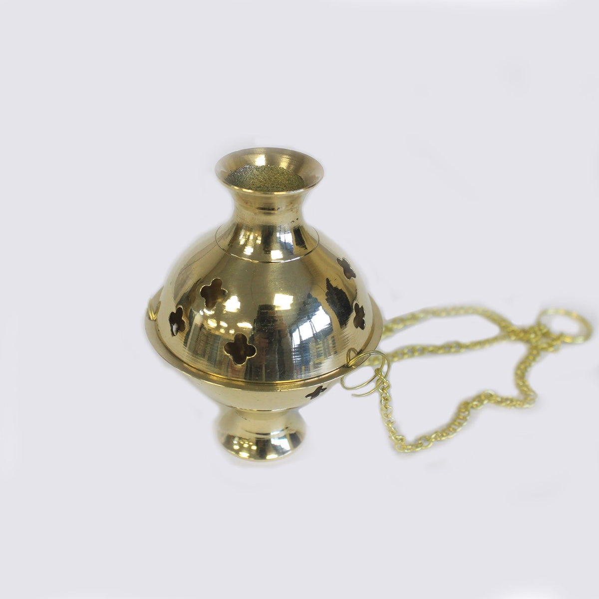 Hanging Brass Incense Burner, polished gold-coloured burner with cut-out flowers and chain on a pale background