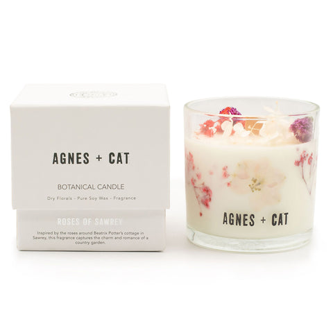 Roses of Sawrey candle beside its white branded box, showing the floral wax through the glass