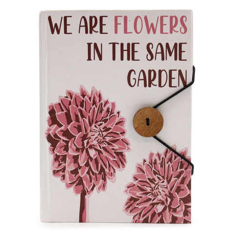 Flowers in the same garden notebook shown upright, with pink flowers and a black strap across the cover