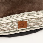 Close-up of the bed’s front fabric and label