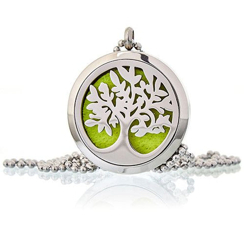 Tree of Life diffuser necklace shown close up from the front, with a green insert and chain on a white surface