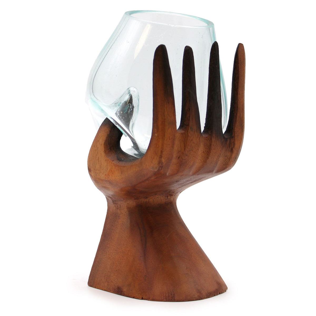 Carved wooden hand supporting a clear glass bowl, shown from the opposite side