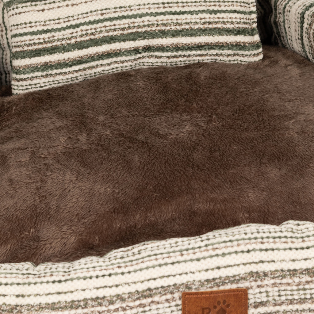 Close view of the brown plush seat and striped cushion