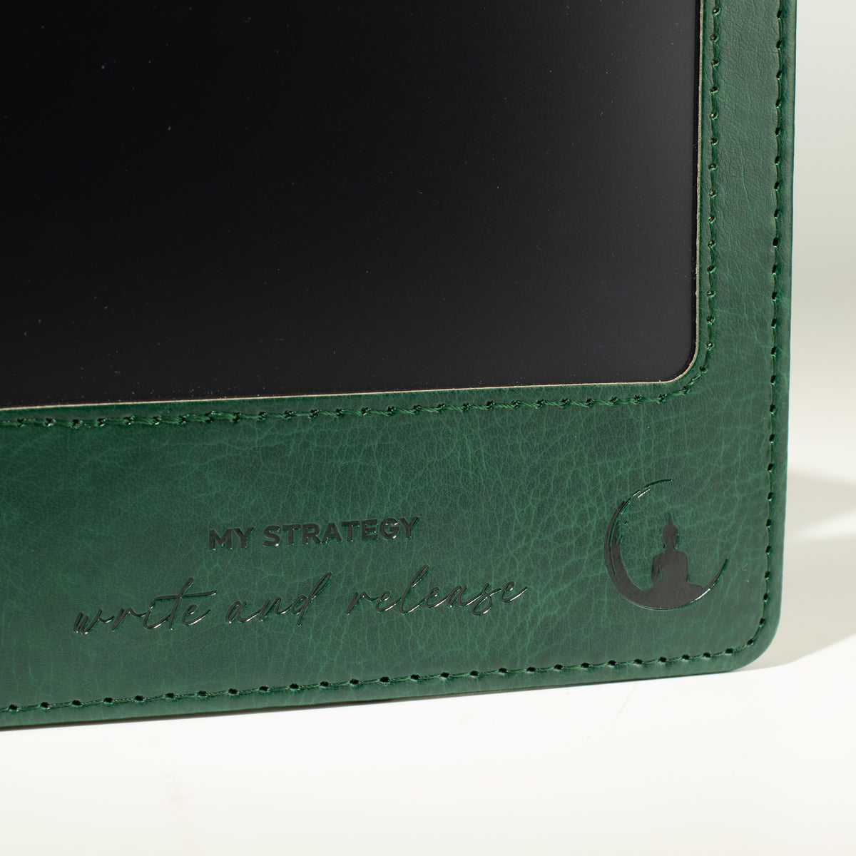 Close-up of the stitched green cover and front screen