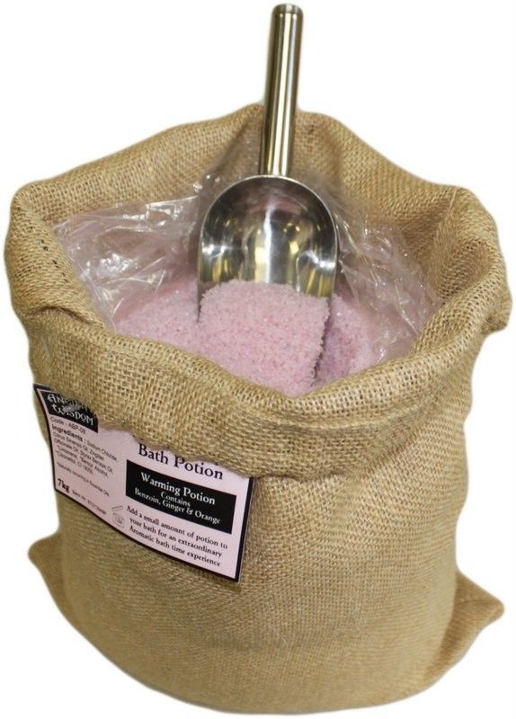 Warming Potion 7kg Hessian Sack open with pink bath potion, a metal scoop and a label