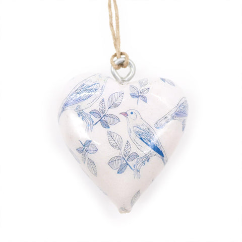 Blue Bird wood heart hanging by twine, close-up of its pale surface with blue birds and leaf patterns