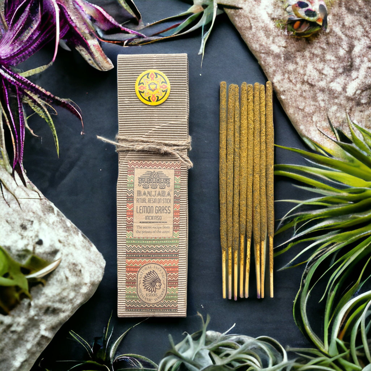 Ritual Resin on Stick, Lemon Grass in a patterned box beside brown sticks, viewed from above