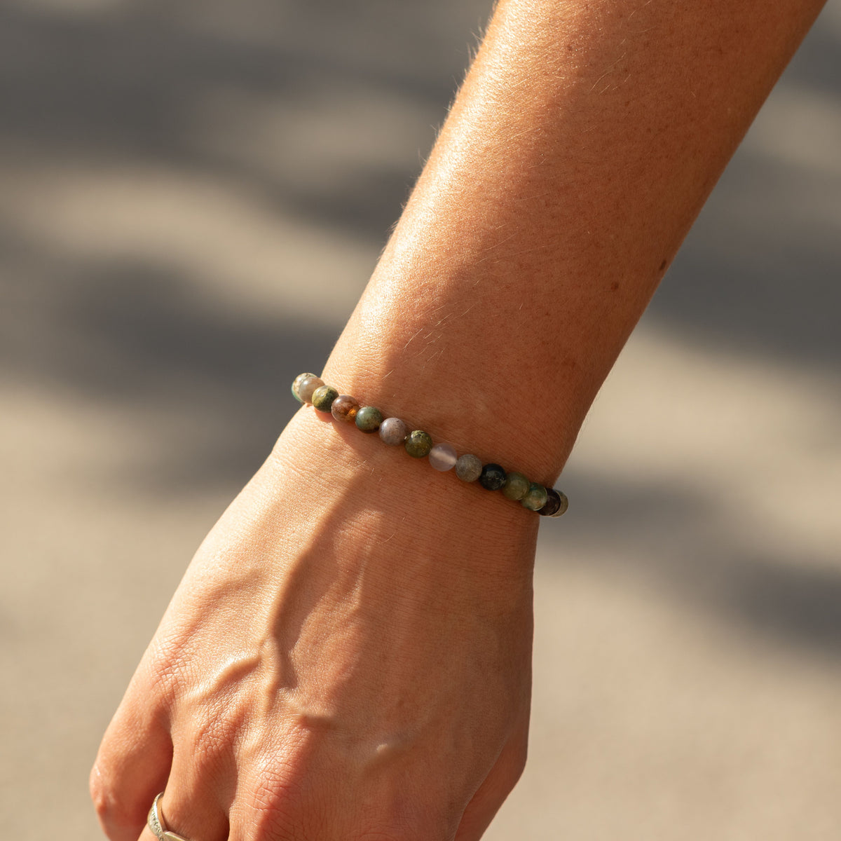 Moss Agate bracelet worn on a wrist
