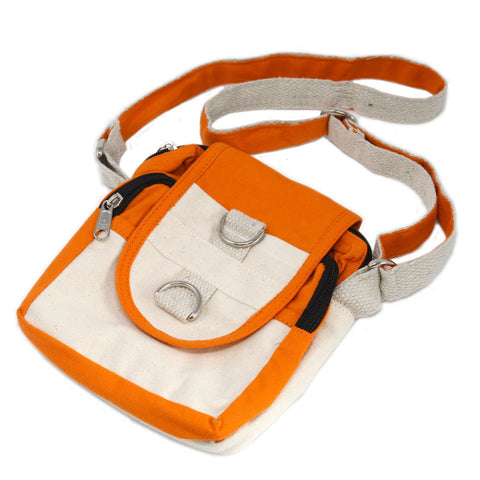 Orange and cream travel bag on a white background, laid at an angle with its shoulder strap spread out