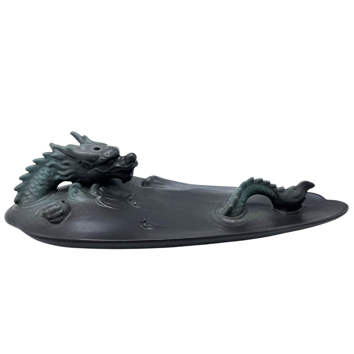 Dragon backflow burner shown from the side, with its raised tail and long dark pool-shaped tray